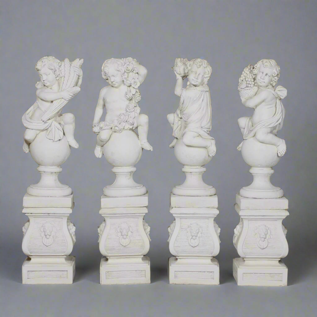 Set of Four Seasons Stone Statues featuring hand-carved cherubs on pedestals, each symbolizing Spring, Summer, Autumn, and Winter in garden decor.