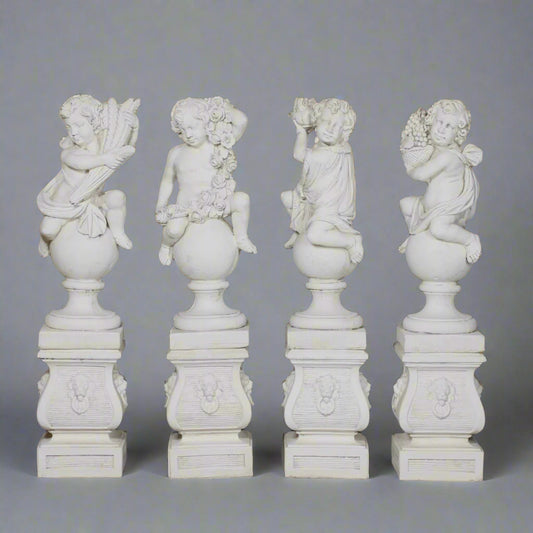 Set of Four Seasons Stone Statues featuring hand-carved cherubs on pedestals, each symbolizing Spring, Summer, Autumn, and Winter in garden decor.