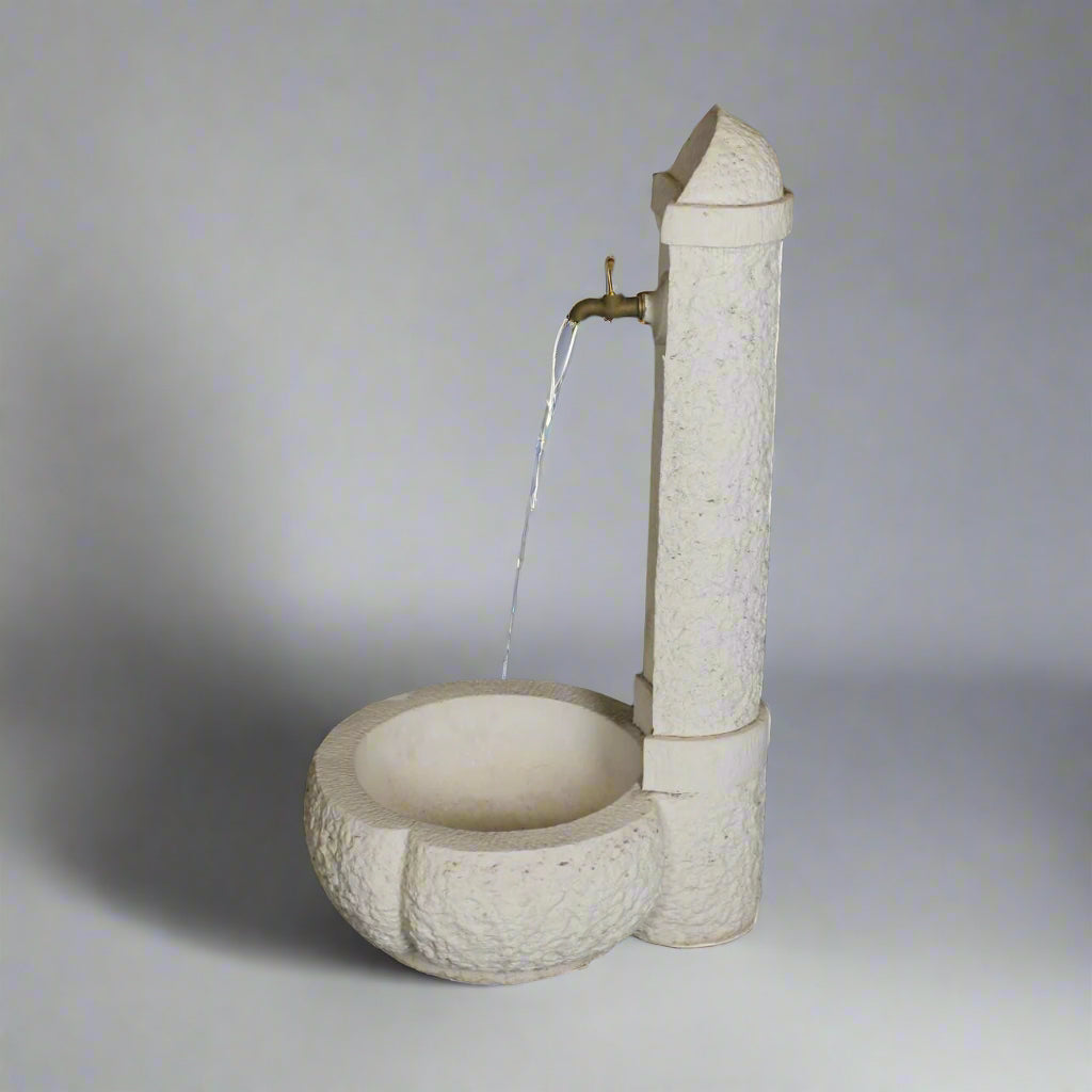 Outdoor Elegance Stone Fountain with water flowing from brass spout into a carved round basin, perfect for enhancing garden ambiance.