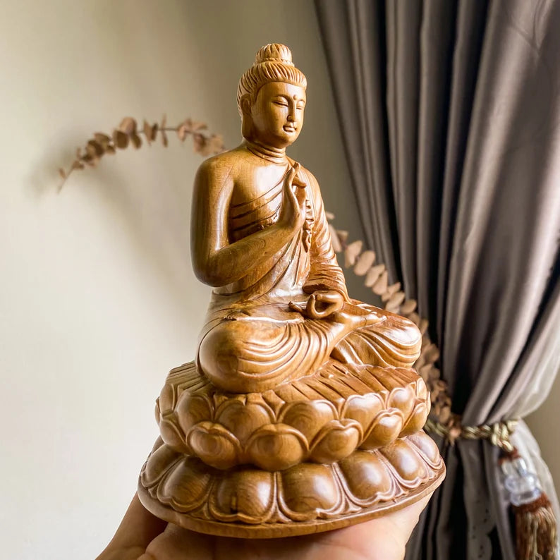 Side angle of Handmade Wooden Abhaya Buddha Statue showing intricate robe details and lotus base, crafted from green cypress wood in Vietnam.