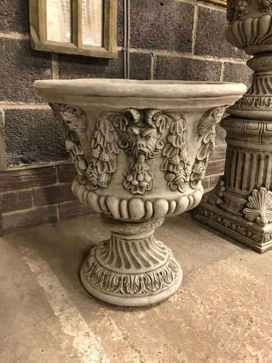 Large Stone Bacchus Garden Planter with weatherproof antique finish, featuring ornate Greco-Roman deity face and garland detailing on stone base.