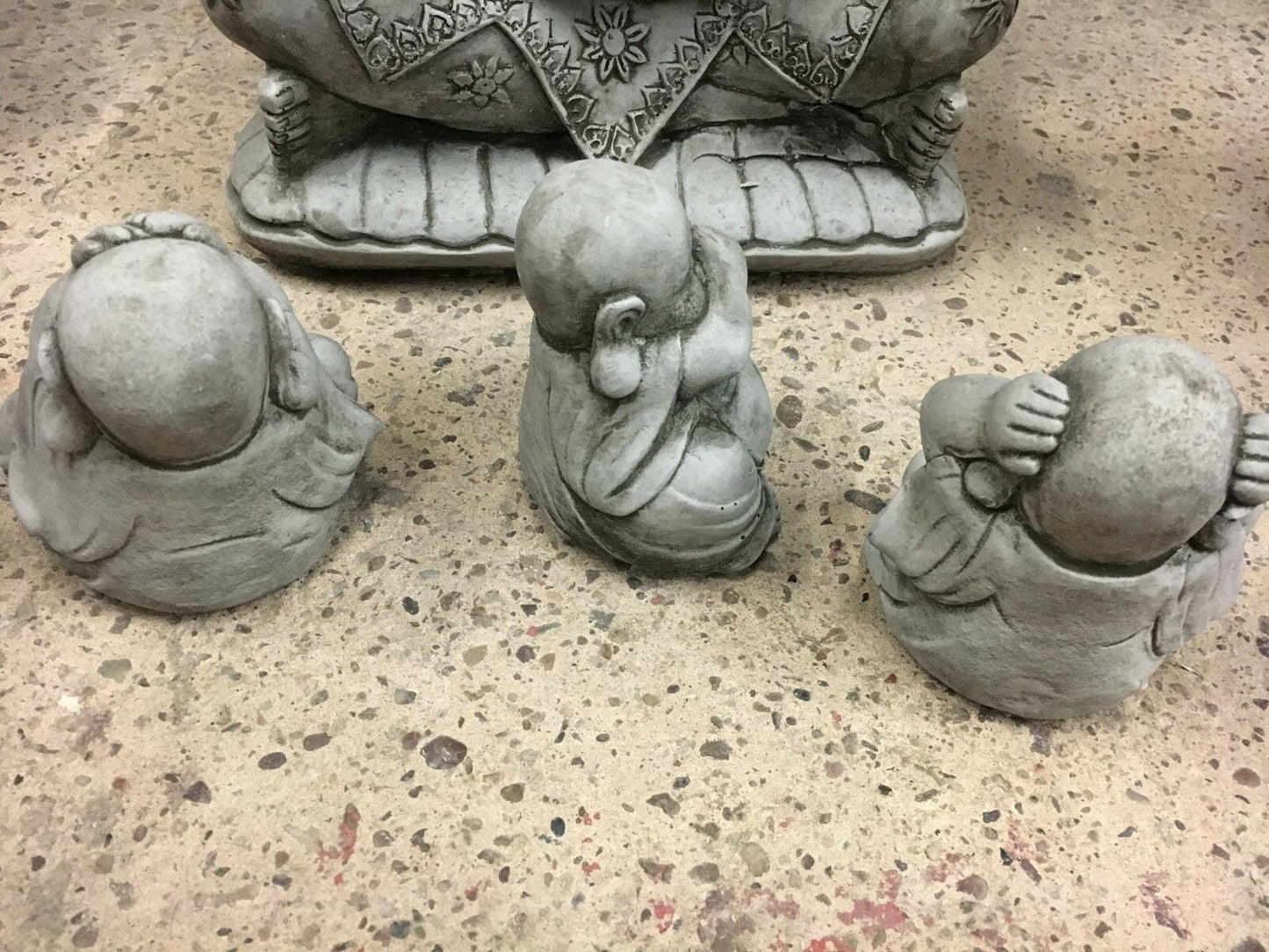 Rear view of Hear, See & Speak No Evil stone Buddha ornaments showing sculpted detail and craftsmanship for garden display.
