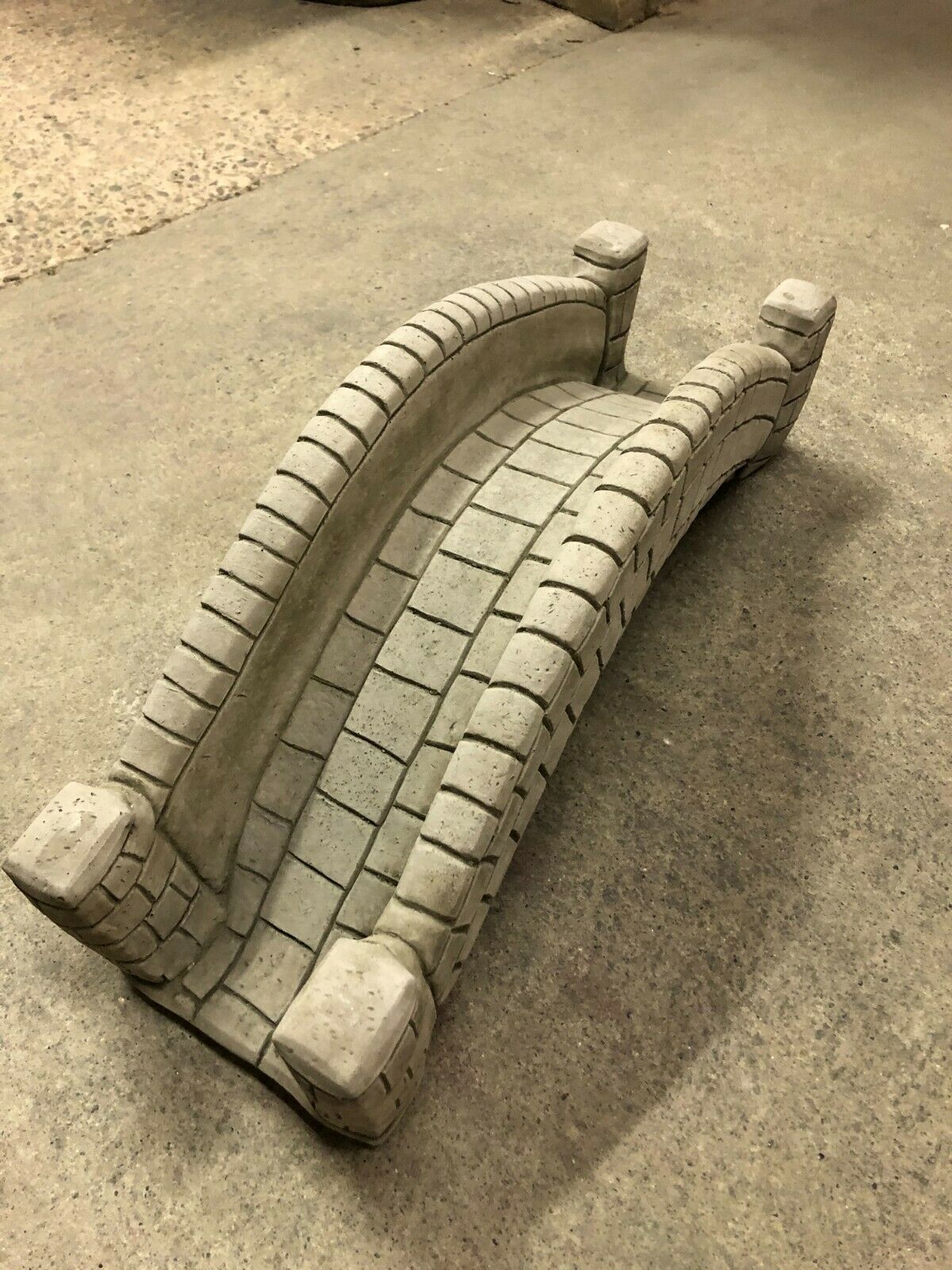 Stone pond bridge garden ornament in antique finish, showcasing curved structure and textured stonework for home and garden decoration.
