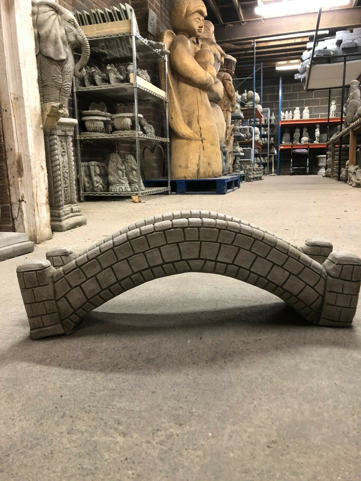 Side profile of stone pond bridge garden ornament with antique finish, perfect for enhancing garden landscapes and pond features.