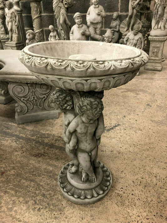 Cherub Garden Bird Bath - Stone Antique Finish with ornate basin and trio cherub pedestal. Ideal for outdoor garden décor and bird feeding.