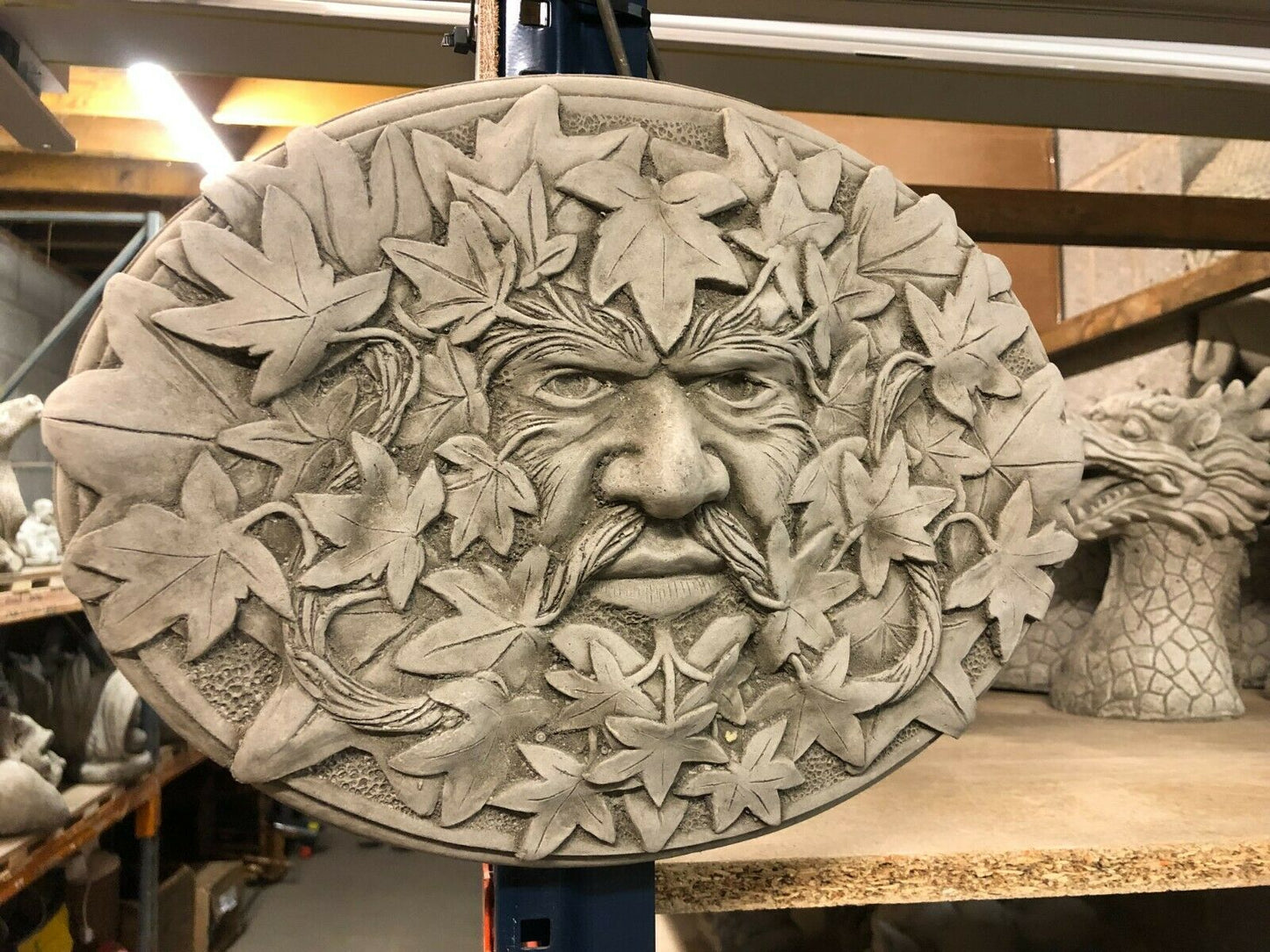 Greenman Plaque-Stone Oval Garden Decor featuring a detailed leafy face design in concrete, ideal for wall hanging in outdoor or indoor spaces.