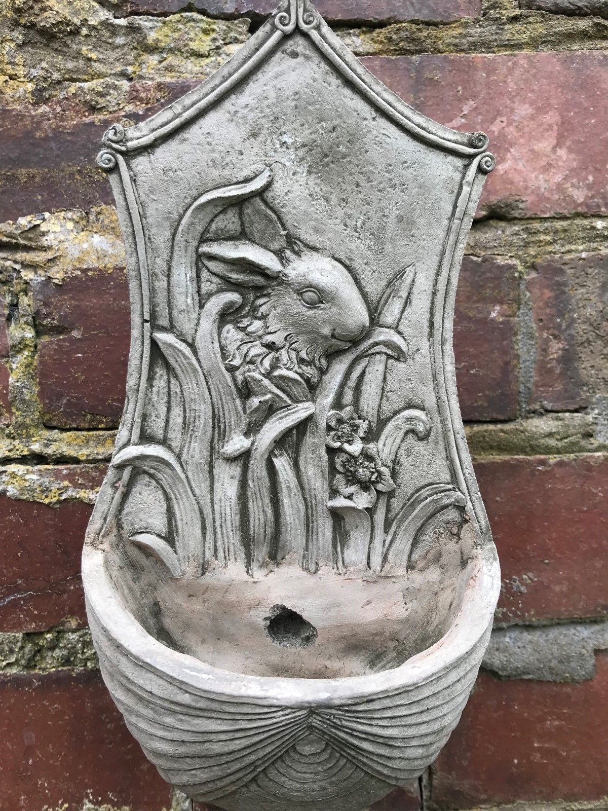 Close-up of Stone Rabbit Planter showing detailed bunny and floral carvings, with built-in drainage for healthy plant growth.