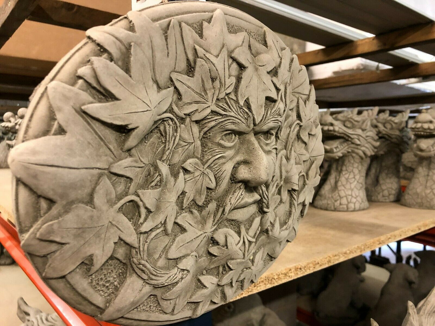 Side view of Greenman Plaque-Stone Oval Garden Decor showing 3D leaf details and textured concrete finish, designed for easy wall mounting.