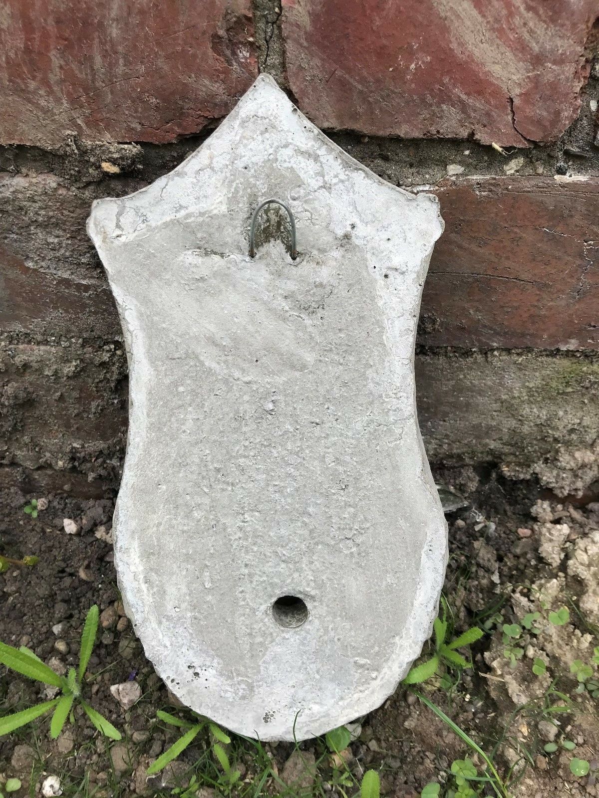 Back view of Stone Rabbit Planter showing mounting hole and drainage opening, designed for secure wall installation.