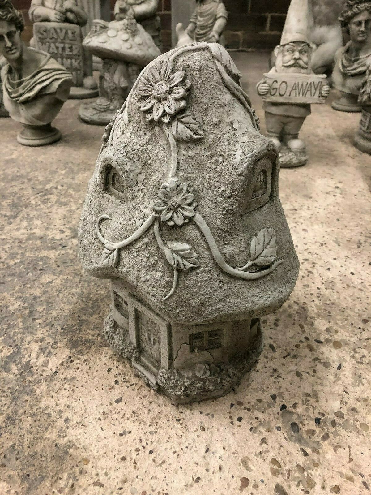 Whimsical Stone Cottage Garden Ornament with intricate vine and flower detailing, ideal for magical garden decor and made from weather-resistant limestone.