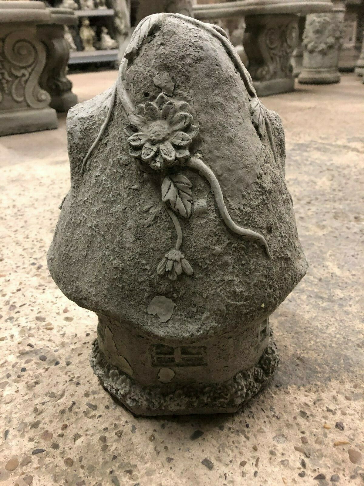 Rear angle of Stone Cottage Garden Ornament with flower relief and textured stone finish, perfect for fairy tale garden themes and outdoor durability.
