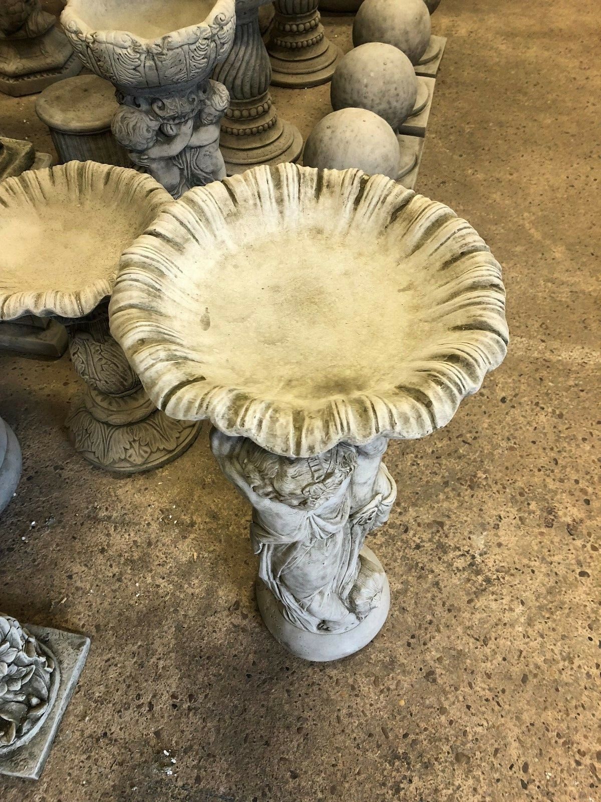 Top view of Stone Cherub Garden Bird Bath with wide scalloped basin and antique grey finish, perfect for attracting birds in decorative gardens.