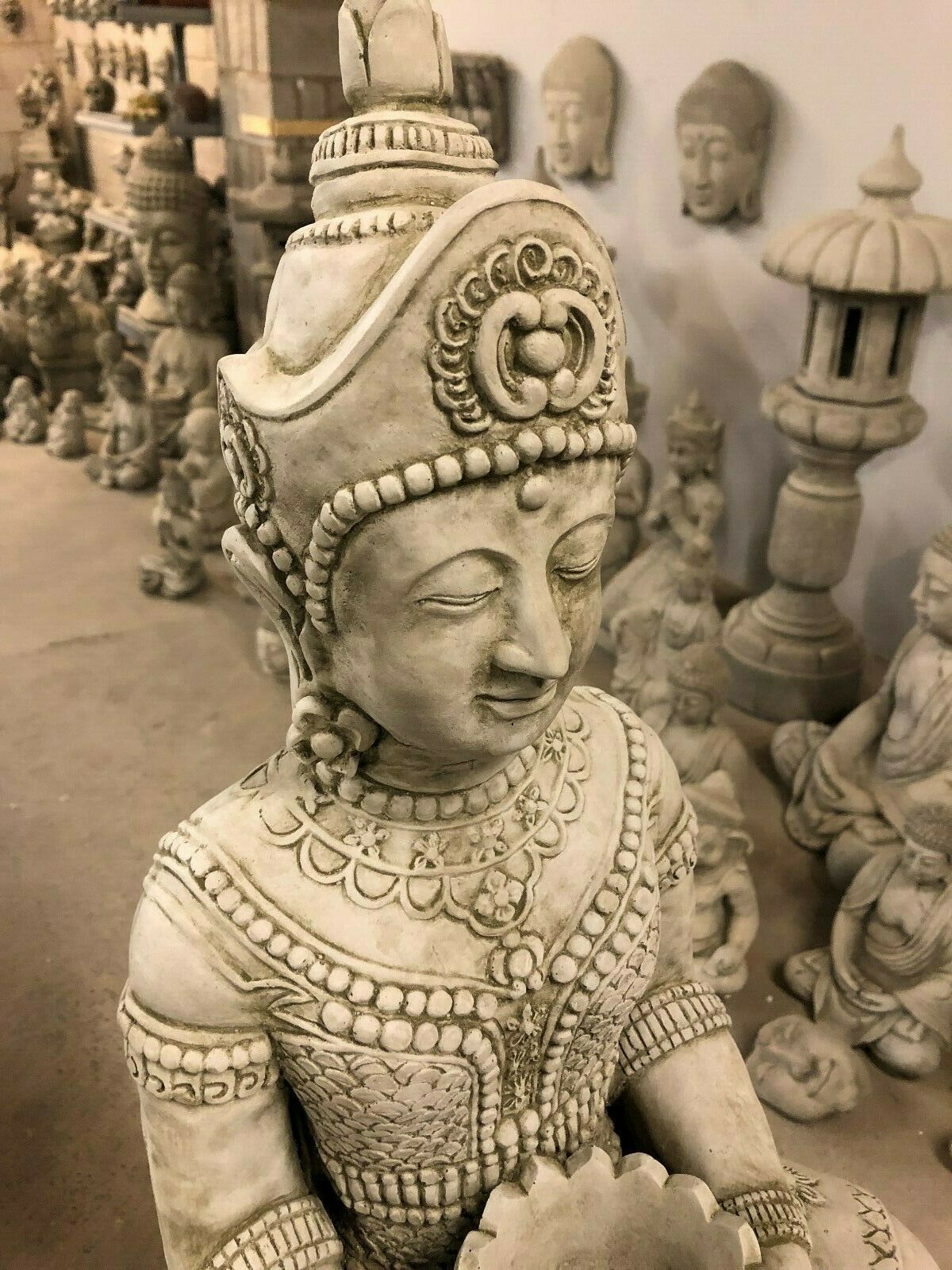 Close-up of Stone Buddha Bust - Garden Ornament's head and facial features, emphasizing serene expression and ornamental headgear.