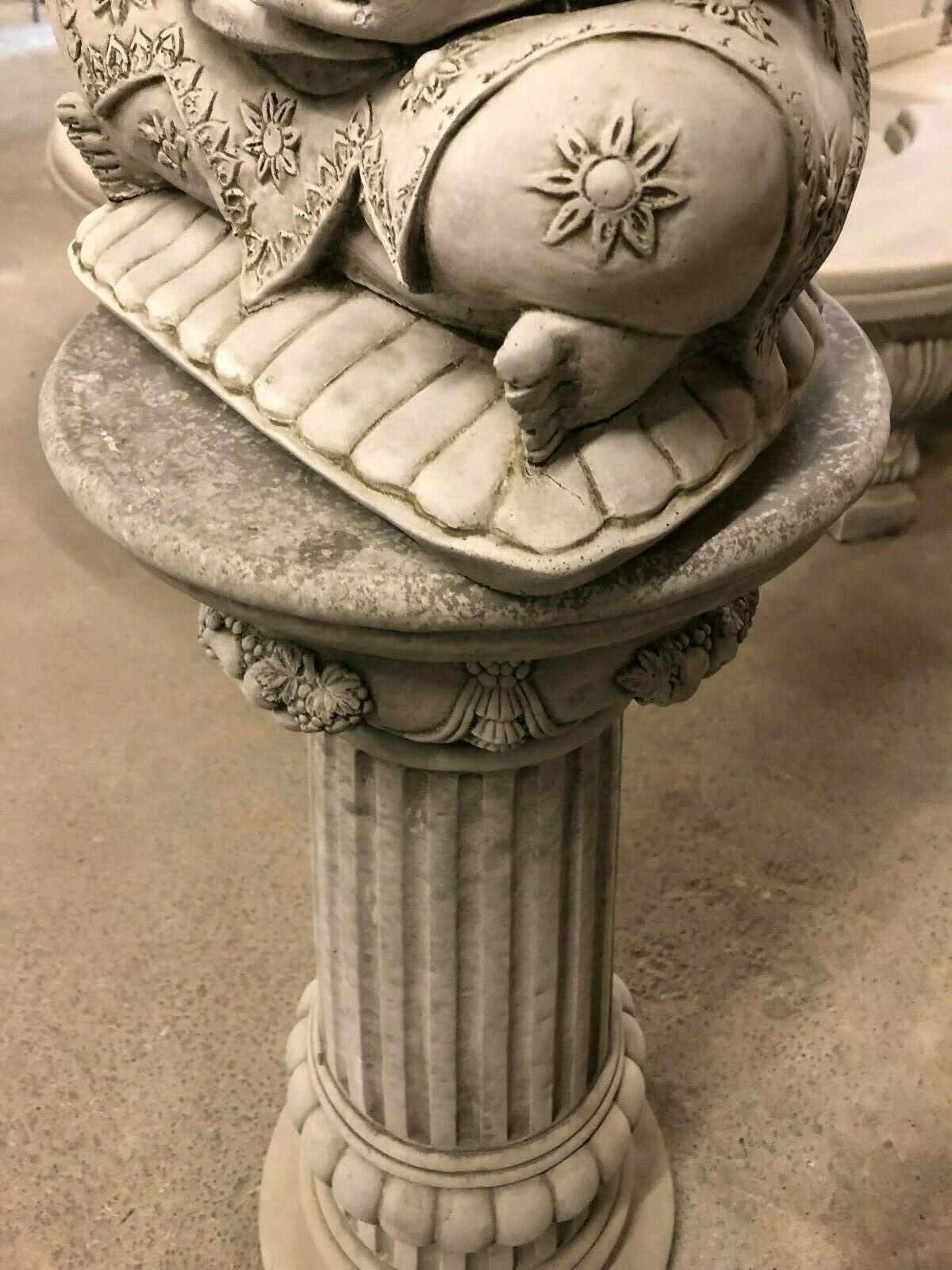 Detail of Stone Buddha Bust - Garden Ornament's base and lotus cushion, resting on a carved stone plinth with floral accents.