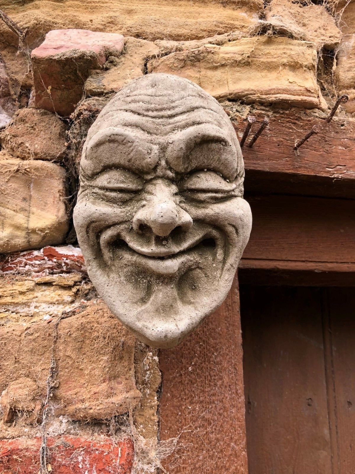 Stone Smug Face Wall Plaque