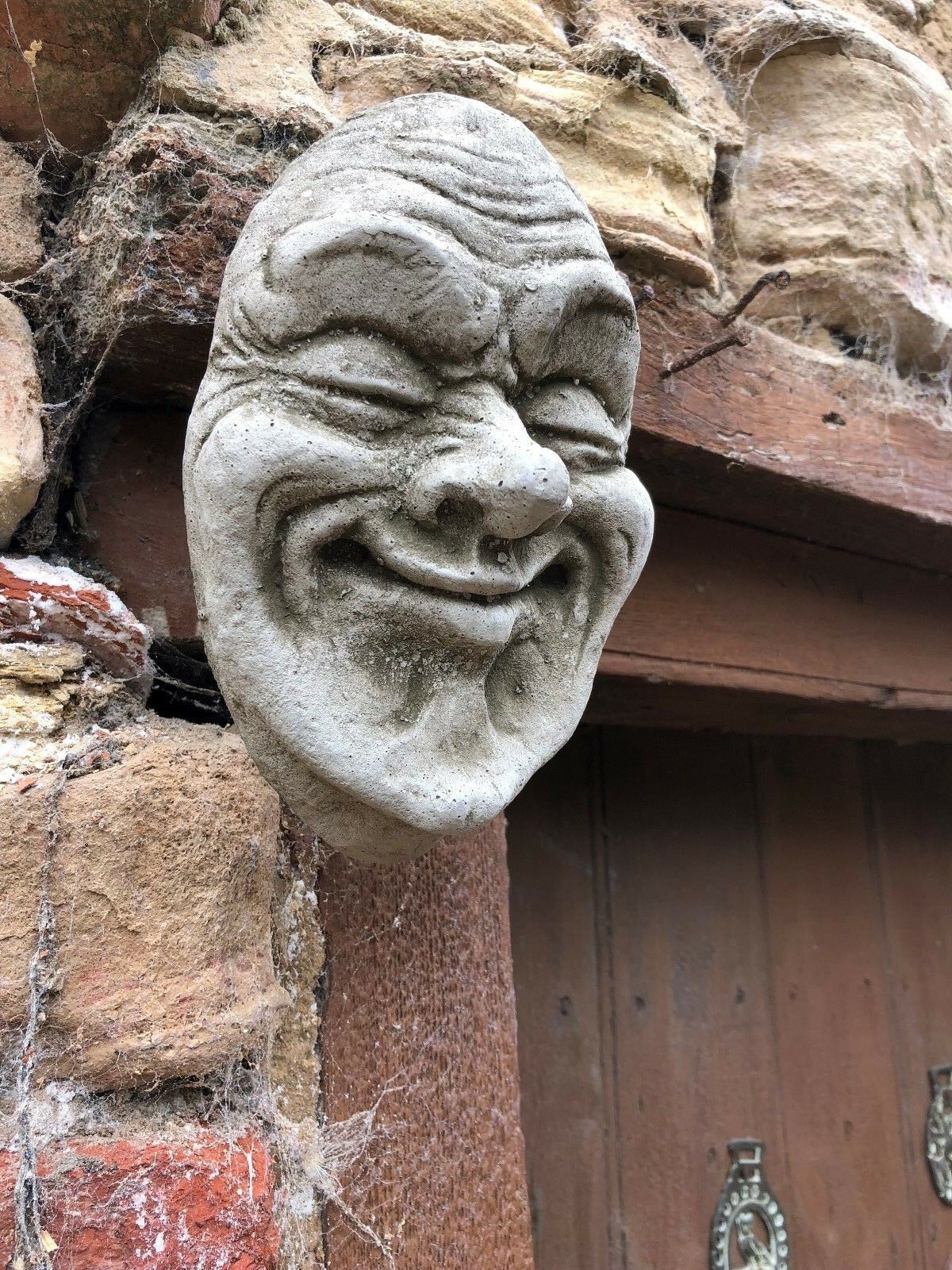 Stone Smug Face Wall Plaque